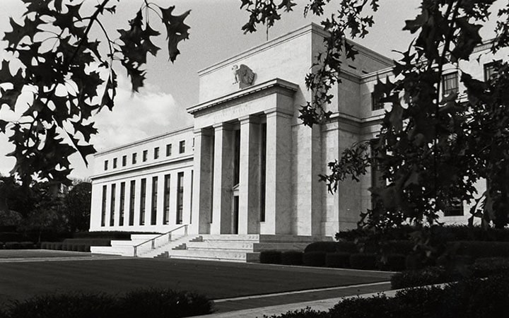 A black-and-white photograph of the Federal Reserve building.