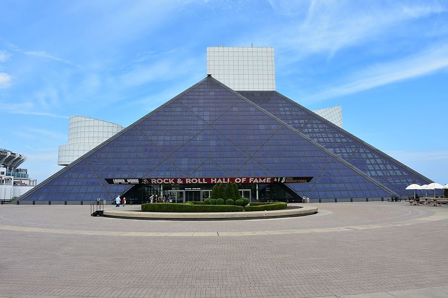 A colored photograph of the Rock and Roll Hall of Fame building in the daytime.